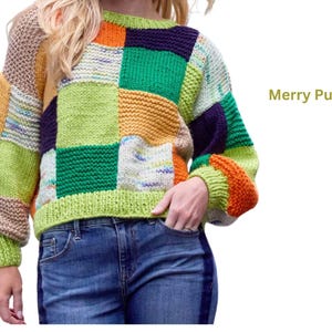 May include: A patchwork knit sweater with a crew neck and long sleeves. The sweater features a variety of colors, including green, orange, yellow, and blue. The text "Merry Pullover" is displayed on the right side.