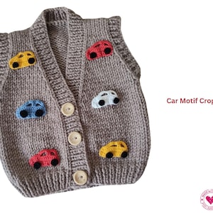 May include: A knitted, taupe crop vest decorated with colourful car appliqués. The vest has a V-neck, wooden buttons, and small car designs in yellow, red, blue, and white. The text "Car Motif Crop Vest" is visible.