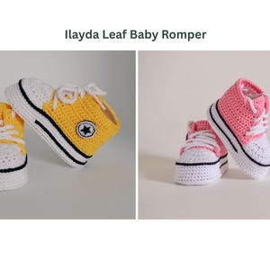 May include: Crocheted baby shoes in yellow and pink. The yellow shoes have a black star on the side and white laces. The pink shoes have white laces and a black stripe on the sole. The text "Ilayda Leaf Baby Romper" is at the top.