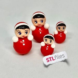 May include: Four red, round, hand-painted dolls with white accents and black hair, each wearing a white-trimmed red hat. The dolls have painted faces with blue eyes. The smallest doll has a sticker that says "STLfiles".
