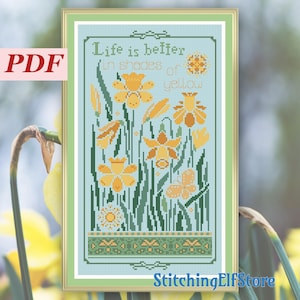 May include: Cross stitch pattern featuring a blue background with yellow daffodils and the text "Life is better in shades of yellow".