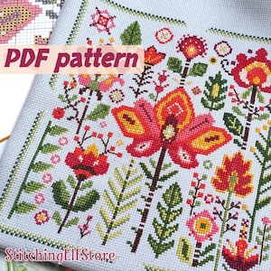 May include: A cross-stitch pattern featuring a floral design with red, orange, yellow, and green flowers and leaves. The text "PDF pattern" is visible. The design is on a light blue fabric.