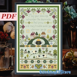 May include: A framed cross-stitch design with a green border. The pattern includes the text "May your blessings outnumber the shamrocks..." and images of houses, trees, sheep, and a pot of gold. The word "PDF" is in the upper left corner.