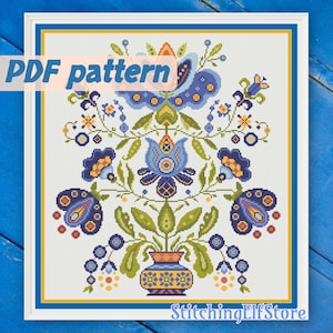 May include: A PDF pattern for cross-stitch embroidery featuring a colorful floral design with blue, yellow, and green flowers in a vase. The design is reminiscent of folk art.