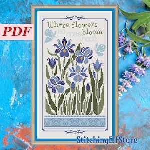May include: Cross stitch pattern featuring blue irises and butterflies with the text "Where flowers bloom so does hope".