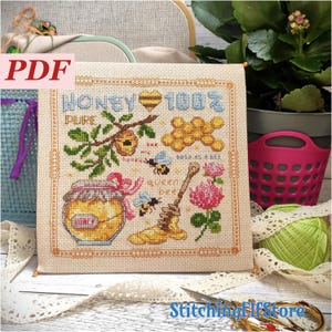 May include: A cross-stitch design featuring a honey-themed illustration. The design includes a jar of honey, bees, honeycomb, and the words "Honey 100% Pure." The design is framed with a decorative border and the word "PDF" is in the upper left corner.