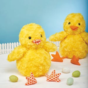 May include: Two fluffy yellow chick toys with orange beaks and black eyes. The scene includes orange star decorations and speckled eggs in green, white, and blue. The background is a light blue.