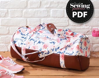 May include: A floral print duffel bag with brown leather accents and handles. The bag features a white background with pink and blue floral patterns. The image also includes a pair of pink sneakers and a water bottle. The bag has the text "Simply Sewing patterns PDF".