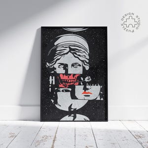 May include: Black framed art print featuring a fragmented illustration of a classical bust with a red skull and rose. The artwork has a starry background and the word "H" is visible. The print is leaning against a white wall.