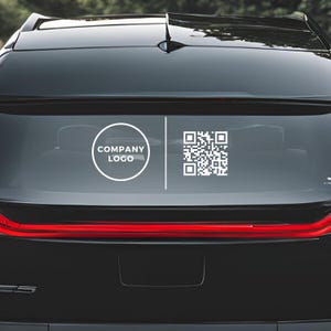 May include: A black car with a white circle containing the text "COMPANY LOGO" and a white QR code on the rear window.