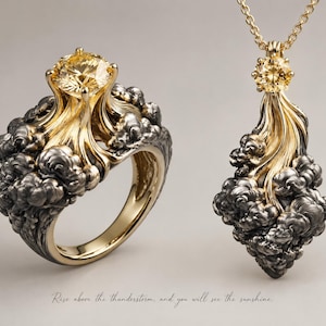 May include: A gold ring and a matching pendant necklace featuring a central yellow gemstone set amidst dark, textured metal clouds. The text below reads: Rise above the thunderstorm, and you will see the sunshine. The jewelry set displays a contrast between the polished gold and the dark, oxidized metal finish.