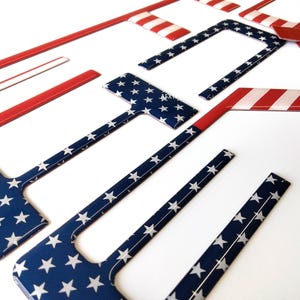 May include: A set of seven decorative trim pieces featuring an American flag design. The trim pieces are made of a durable material and are perfect for adding a patriotic touch to any car or truck.