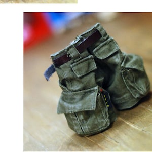May include: A pair of green cargo pants with multiple pockets and a brown belt. The pants are made of a soft, durable fabric and are perfect for everyday wear.