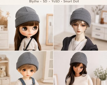 May include: A grey ribbed beanie for dolls, featuring a folded cuff design. The text DOLL RIBBED BEANIE Blythe • SD • YoSD • Smart Doll is displayed above four images of different dolls wearing the same grey knit hat in a simple style.