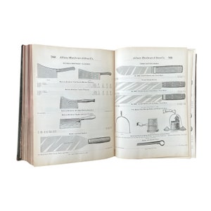 May include: An open book with two pages showing a catalog of kitchen knives and other tools. The book is titled "Albany Hardware & Iron Co." and features illustrations of various cleavers, butter knives, and other kitchen tools.