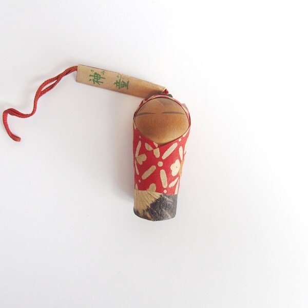 Twinkly Bell Japanese Baby Doll Ornament On A Strap Wrapped in Red Blanket Worldwide Shipping