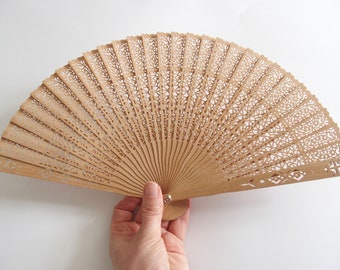 Chinese Style Folding Fan With Intricate Ornamental Cutout Design