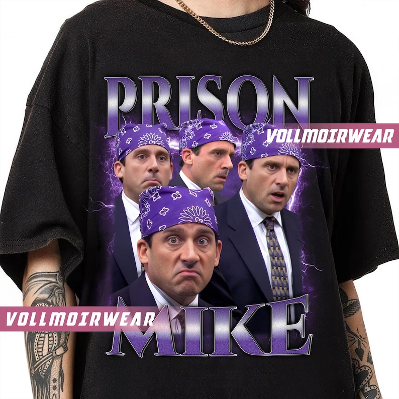 May include: Black t-shirt featuring a graphic of Michael Scott from The Office wearing a purple bandana. The word "PRISON" is above the image, and "MIKE" is below. The brand name "VOLLMOIRWEAR" is also visible.