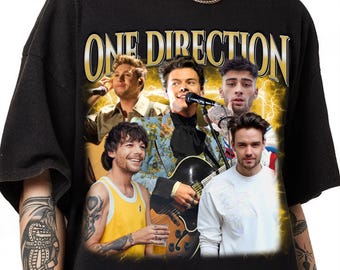 May include: Black t-shirt with a vintage-style graphic of the band One Direction. The graphic features the five band members in a collage style with a yellow and gold background.