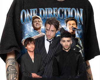 May include: Black t-shirt with a graphic print of the band One Direction. The graphic features the band members in a vintage style with lightning bolts and a blue background.