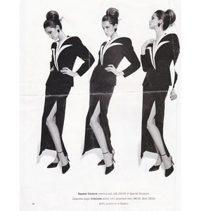 May include: Three black and white photos of a woman wearing a black suit with a white trim. The suit has a long skirt with a slit up the side. The woman is wearing a black hat and has her hair pulled back. The text on the page reads "Daymor Couture evening suit, 418; 520.00. In Special Occasion. Opposite page, Criscione jacket with attached vest; 380.00, Skirt; 130.00. Both, xs-s-mixt. In Gallery."