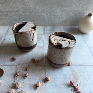 Side profile of pottery to-go mug with speckled beige and brown toasted accents, handmade for outdoor use, holidays, or 9th anniversary pottery gifting