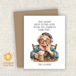 May include: A greeting card with a cartoon illustration of an elderly man laughing while holding a beer. The card reads "DON'T WORRY ABOUT GETTING OLDER. YOU'RE STILL GONNA DO DUMB STUFF... ONLY SLOWER!" A brown envelope is behind the card.