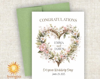 May include: A wedding card with a floral heart design, featuring the names "EMMA and JAMES" and the date "June 29, 2025." The card is accompanied by a green envelope. The text "CONGRATULATIONS" and "On your Wedding Day" are also visible.