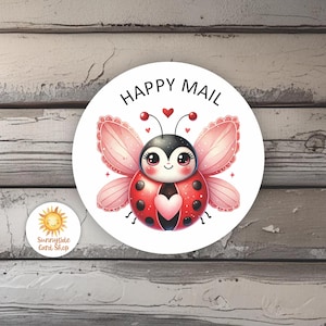 May include: A round sticker with a cartoon ladybug design. The ladybug is red with black spots and a heart-shaped design on its back. The sticker has the words "HAPPY MAIL" and a small sun logo.