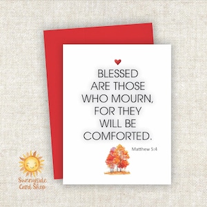 May include: A white card with the text "BLESSED ARE THOSE WHO MOURN, FOR THEY WILL BE COMFORTED." and a watercolor image of trees. A red envelope is behind the card. The text "Matthew 5:4" is also on the card.