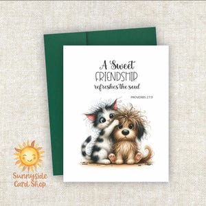 May include: Greeting card with a watercolor illustration of a kitten and puppy hugging. The card reads "A Sweet Friendship refreshes the soul" with Proverbs 27:9 below. The card is white with a green envelope.