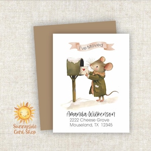 May include: A white moving announcement card featuring a watercolor illustration of a mouse in a green coat and scarf placing a letter with a red heart into a mailbox. Above the mouse is a banner reading I'VE MOVED and below is custom text.