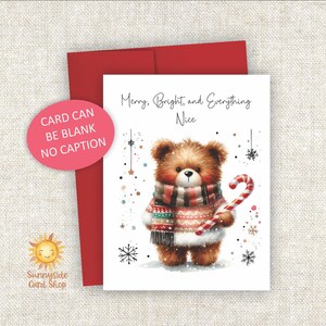 May include: A Christmas greeting card featuring a watercolor illustration of a brown teddy bear wearing a scarf and sweater, holding a candy cane. The card reads "Merry, Bright, and Everything Nice". Includes a red envelope.