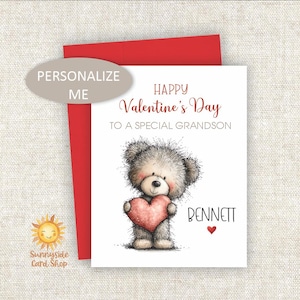 May include: Valentine's Day card with a teddy bear holding a pink heart. The card reads "Happy Valentine's Day to a special grandson" and is personalized with the name "Bennett". A red envelope is behind the card.