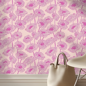 May include: A light pink floral wallpaper with a repeating pattern of pink flowers. A white tote bag and a white chair are in the foreground. The floor is made of light brown wood.
