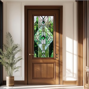May include: A wooden door with a stained glass window featuring geometric shapes in shades of green, white, and clear. The door has a dark brown finish, a gold handle, and a panel at the bottom. A potted plant is to the left.