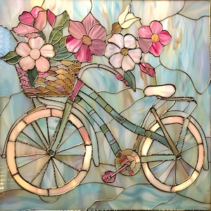 May include: Stained glass artwork featuring a bicycle with a basket overflowing with pink and white flowers. The bicycle is light blue and pink, with intricate details in the glass. The background is a soft, abstract design in shades of blue and white.