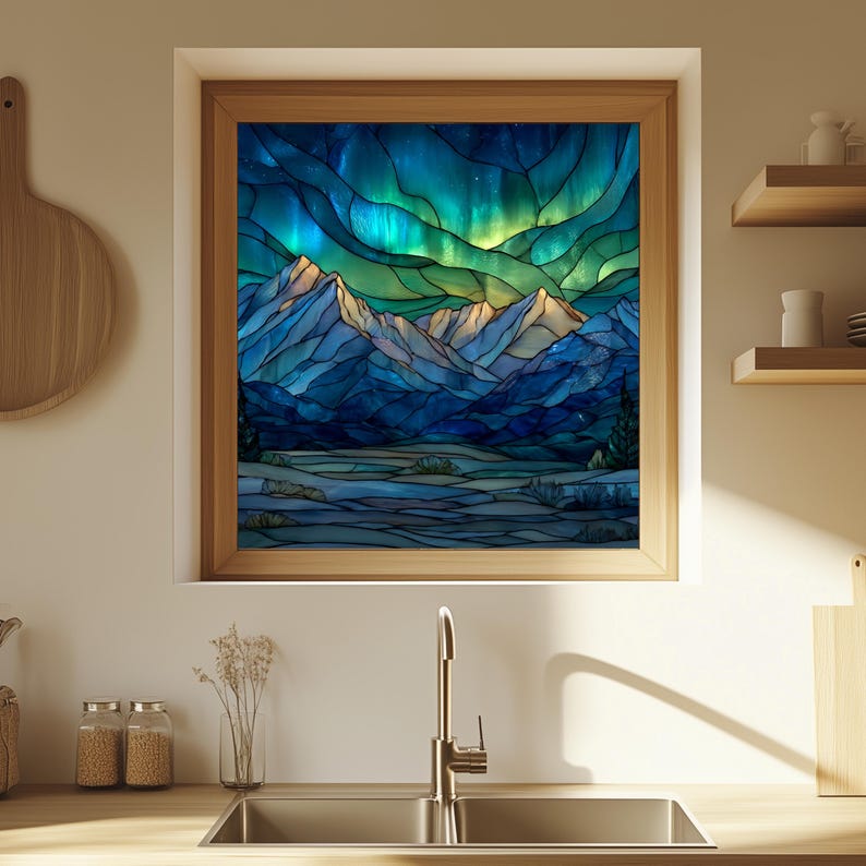 May include: A framed stained glass artwork depicting a mountain landscape under a vibrant aurora borealis. The artwork features shades of blue, green, and yellow, with a wooden frame. The image is displayed in a kitchen setting.
