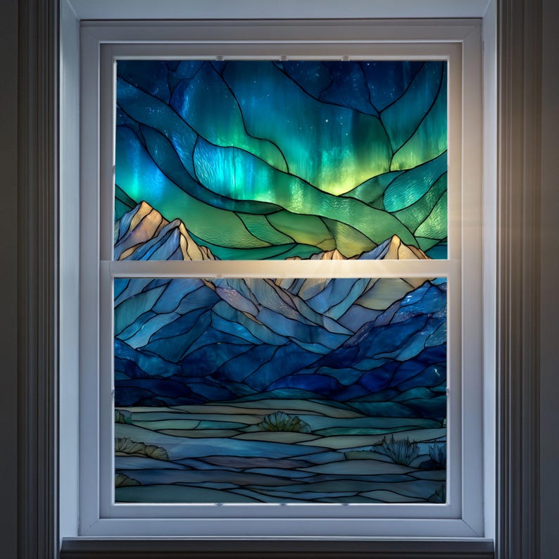 May include: A stained glass window depicting a landscape with mountains and an aurora borealis. The upper portion features vibrant blues, greens, and yellows, while the lower section showcases cooler blues and whites. The window is set within a white frame.