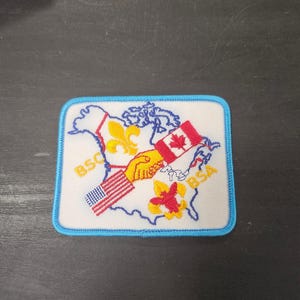 May include: A set of three ceramic mugs with a speckled, matte finish. The mugs are in shades of cream, light gray, and dark gray. Each mug has a simple, minimalist design and a rounded handle.