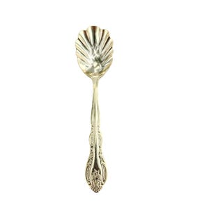 May include: A silver-toned metal spoon featuring a bowl shaped like a scalloped shell. The handle is decorated with intricate embossed floral and scrollwork patterns that extend from the base of the bowl down to the rounded end of the handle.