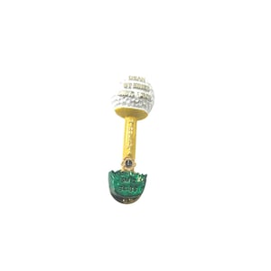 May include: A golf-themed souvenir pin with a white golf ball top, a gold-colored stem, and a green base. The pin has text that reads "DEAN STEINER, SEPT. 1973, 1974" and "MINNESOTA". The base has the text "SM-2 84-86".