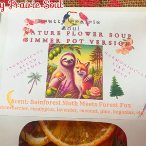 May include: White paper bag with a pink and white label that reads "Pretty Prairie Soul Nature Flower Soup Simmer Pot Version". The label features a sloth and fox illustration and the text "Ingredients Blend Together... Harmoniously Like A Soup". The scent is described as "Rainforest Sloth Meets Forest Fox (strawberries, eucalyptus, lavender, coconut, pine, begonias, etc)".