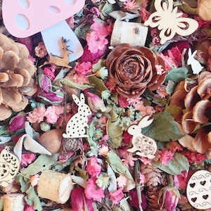 May include: A bowl filled with potpourri, including dried flowers, leaves, and pine cones. There are also wooden cutouts of a mushroom, butterfly, bunny, and deer. The text "Pretty Prairie Soul" is visible at the top of the image.