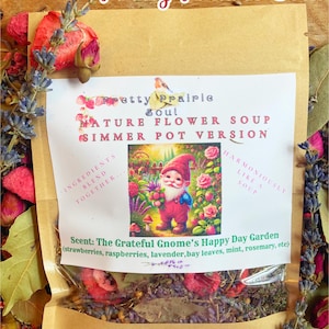 Könnte beinhalten: Ein brauner Papierbeutel mit einem durchsichtigen Plastikfenster, in dem eine Mischung aus getrockneten Blumen und Kräutern zu sehen ist. Der Beutel trägt ein Etikett mit der Aufschrift "Pretty Prairie Soul Nature Flower Soup Simmer Pot Version" und "Scent: The Grateful Gnome's Happy Day Garden (strawberries, raspberries, lavender, bay leaves, mint, rosemary, etc)"