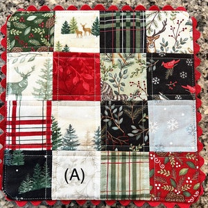 May include: A quilted Christmas-themed square featuring various fabric squares with winter and forest patterns. The squares include deer, trees, and plaid designs. A red scalloped edge frames the design. The letter "A" is visible on one of the squares.