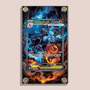 May include: A framed Mega Charizard X EX trading card. The card features a detailed illustration of a black and blue dragon with fiery accents. The card is encased in a clear acrylic frame with gold-colored corner screws.