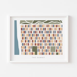 May include: Abstract art print in a white frame. The artwork features a colorful geometric design with rectangular shapes in shades of blue, brown, and yellow. The text "THE SUNSET" is at the bottom.