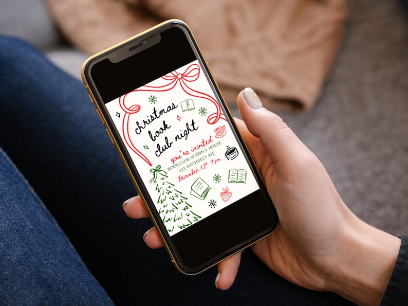 May include: A smartphone displays a Christmas Book Club Night invitation. The invitation features red and green hand-drawn illustrations of a Christmas tree, books, snowflakes, and a coffee cup. The text reads "Christmas Book Club Night" and includes event details.