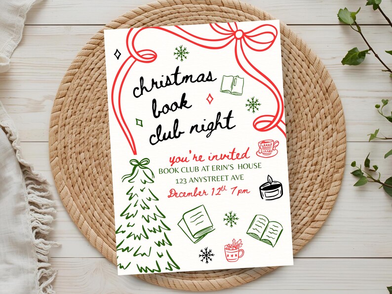May include: A cream-colored invitation for a Christmas book club night, featuring red and green illustrations. The text reads "Christmas Book Club Night" and includes event details: date, time, and location. The invitation is on a woven placemat.